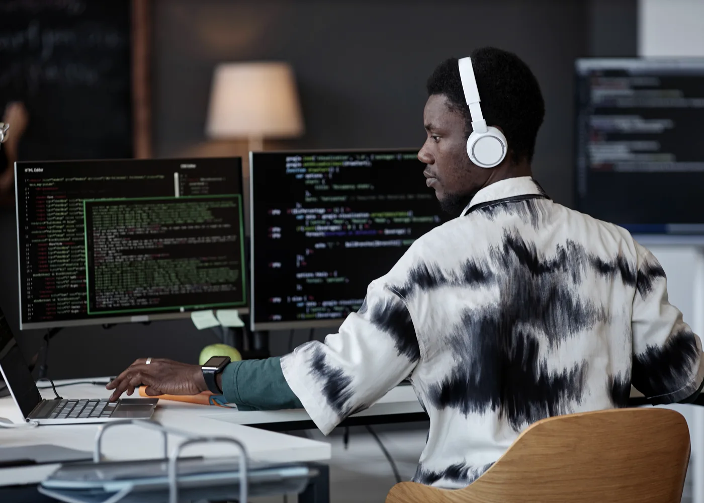 A software engineer working across multiple screens of code