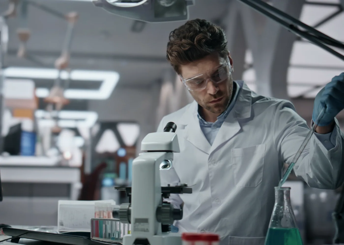 A scientist working at a microscope in a research laboratory